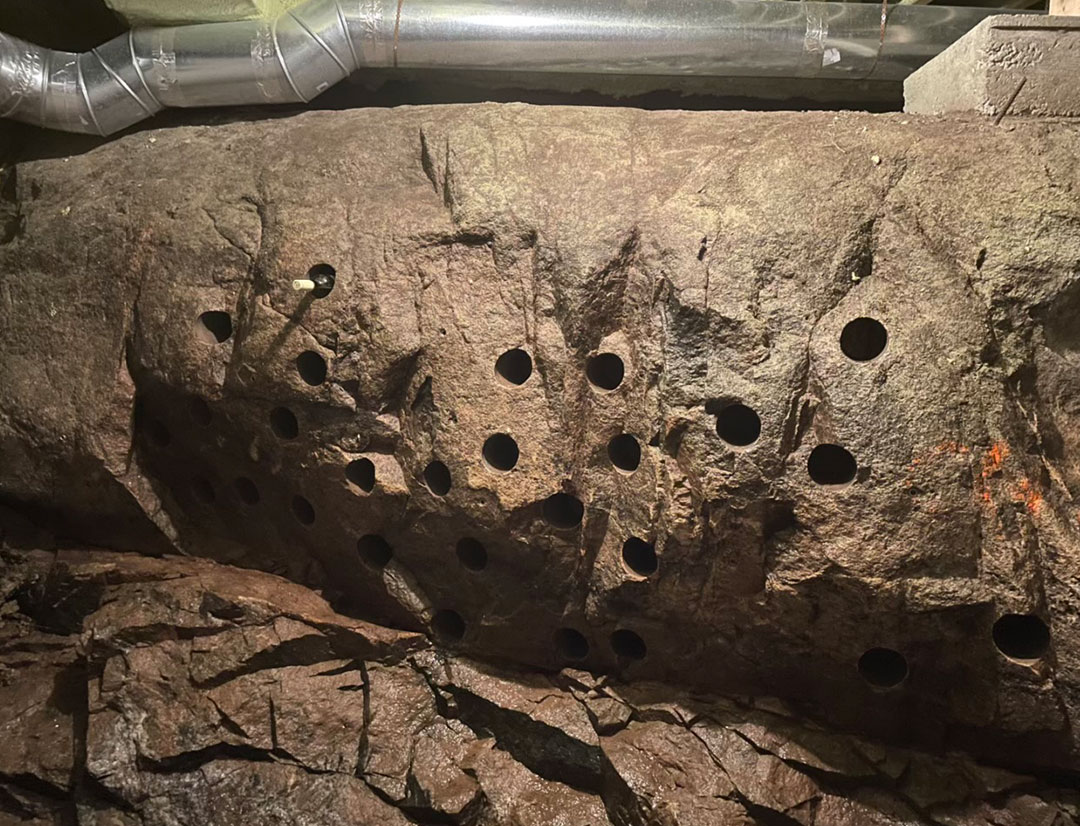 holes drilled in stone to create a natural wine cellar