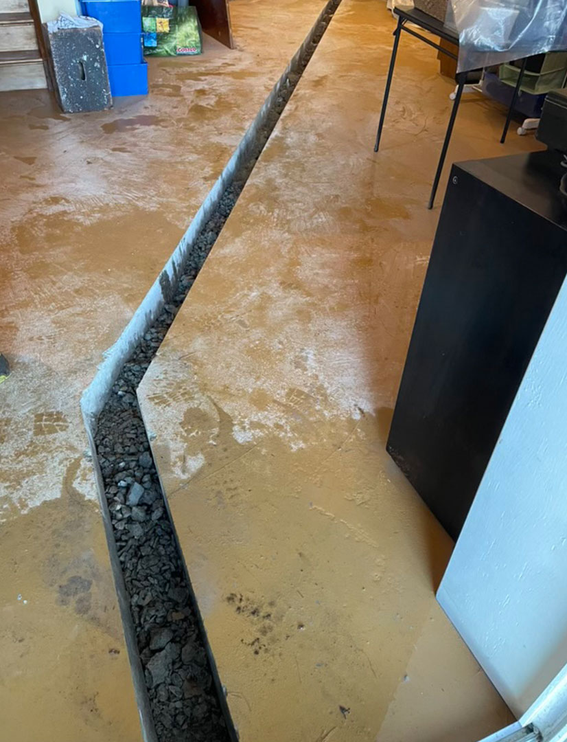 trench made in concrete floor using a slab saw