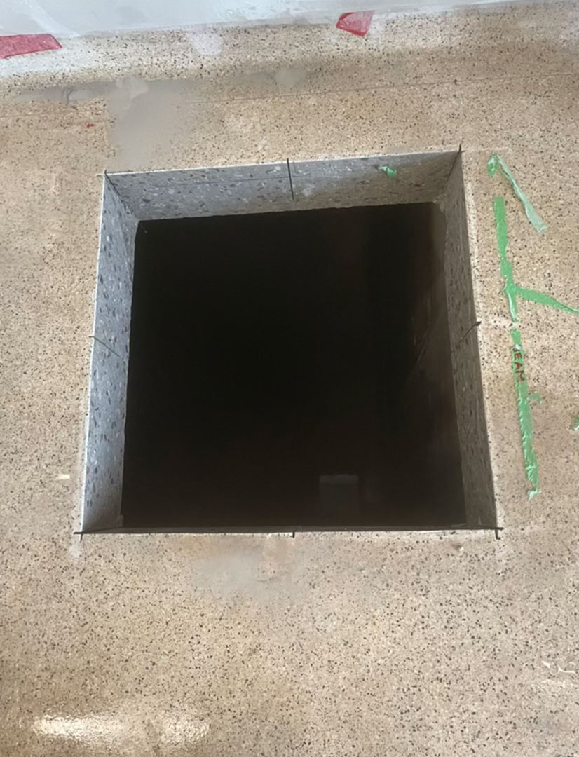 opening made in concrete floor using a slab saw